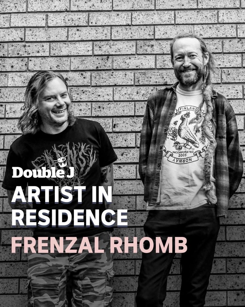 Two smiling people dressed casually standing a bit wonkily up against a brick wall. The taller one is wearing a COFFIN shirt and flanno, the other a rad John Farnham shirt with FARNSY written in black metal font. Superimposed on the photo is the text “Double J 
ARTIST IN RESIDENCE
FRENZAL RHOMB”.