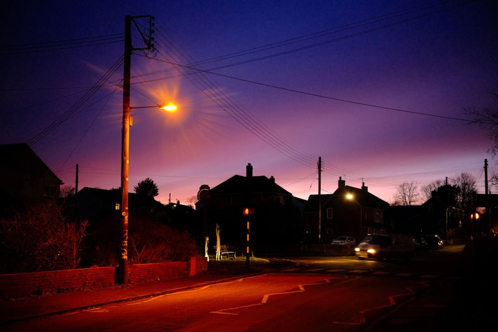 Photo of the street in my village at night. The camera’s daylight white balance has given the photo a reddish cast. 
