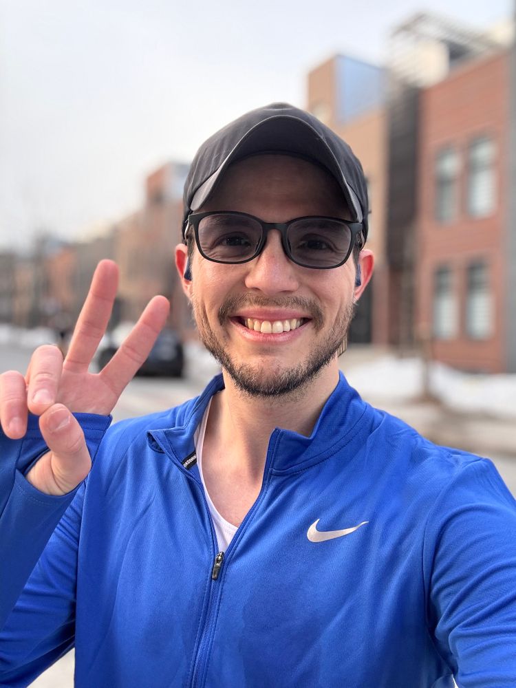 Selfie after a run. I’m wearing a black cap, blue running shirt and sunglasses. 