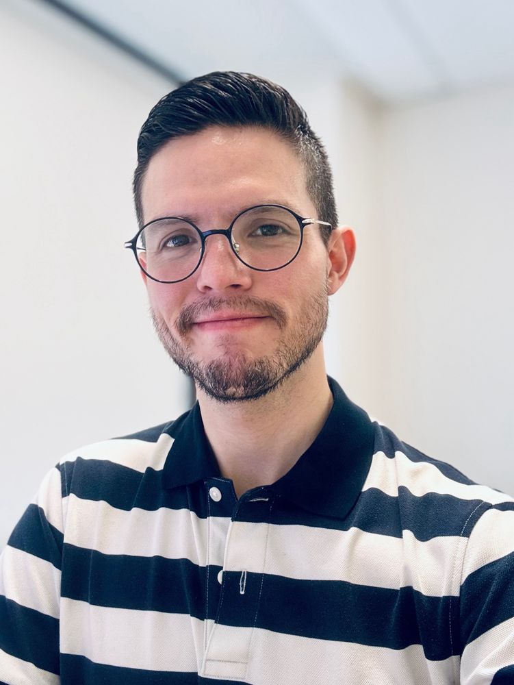 Selfie in the office with a striped polo shirt. 