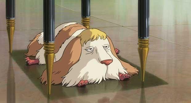 A dog, resembling a mop, lays under a table.  From "Howl's Moving Castle"