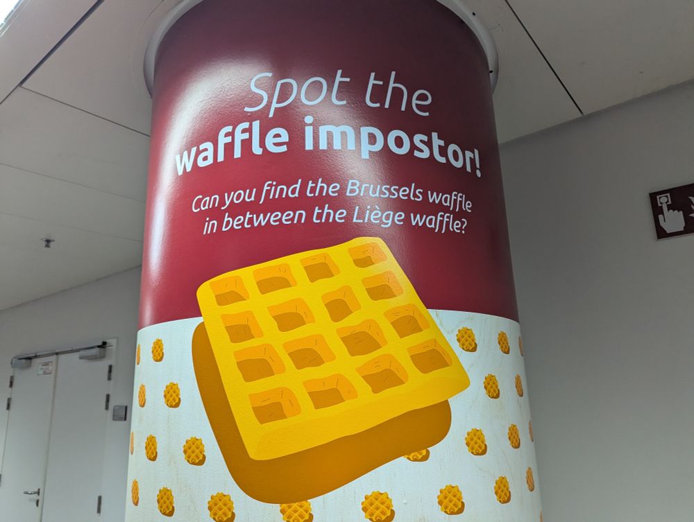 A pillar that says "Spot the waffle impostor! Can you find the Brussels waffle in between the Liège waffle?" A large graphic demonstrates that a Brussels waffle is square. The rest of the pillar is covered in smaller images of circular Liège waffles.