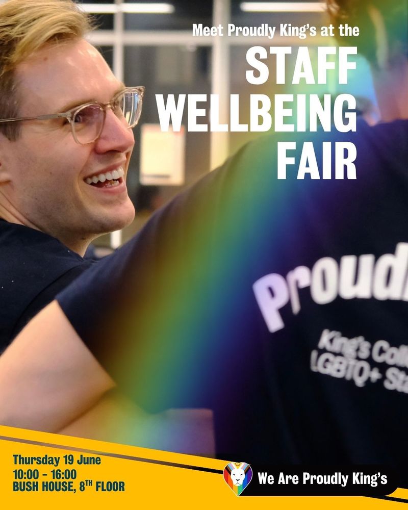 Promotional poster for the 'Staff Wellbeing Fair'. The background features a person with short blonde hair and glasses, and another person in a dark shirt with partially visible text reading 'Proudly King's College LGBTQ+ Staff.' A rainbow overlay covers the image. The main text says: 'Meet Proudly King's at the STAFF WELLBEING FAIR.' Additional details at the bottom read: 'Thursday 19 June, 10:00 - 16:00, BUSH HOUSE, 8TH FLOOR.' A heart-shaped logo with rainbow colors and the text 'We Are Proudly King's' is also present
