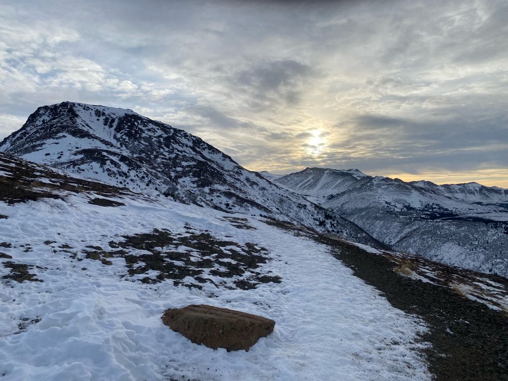 Middle of the day, around 12:30 PM, the sun barely reaches above the peaks