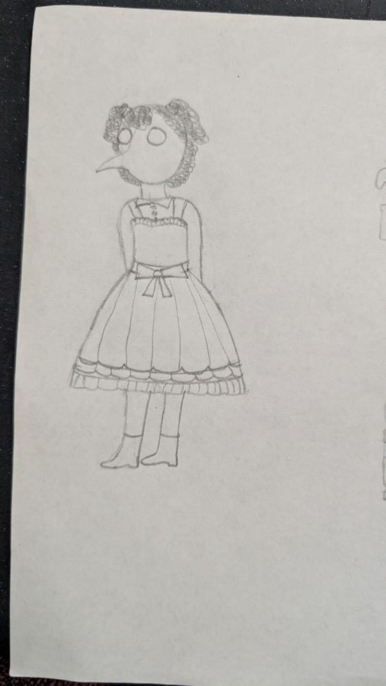 picture of pietro in gothic lolita but right side up. he is standing in his pretty ruffly knee length dress with his hands behind his back.