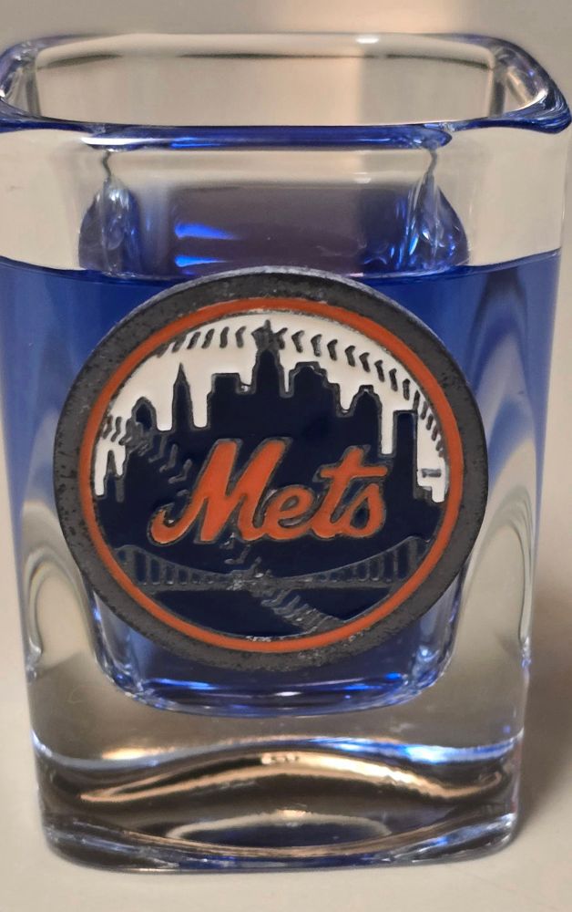 NY Mets shot glass filled with blue liquor.