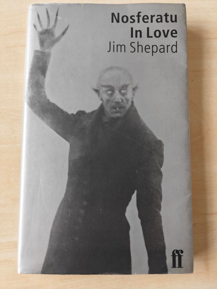 A copy of the book Nosferatu in Love by Jim Shepard. The cover is pale grey with a picture of Count Orlok from the film Nosferatu on the front. It has a Faber and Faber logo in one corner. 
