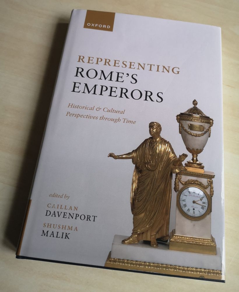 Picture of the book 'Representing Rome's Emperors' by Caillan Davenport and Shusha Malik. The cover is white and shows a rococo clock incorporating a gilded figure of Nero.