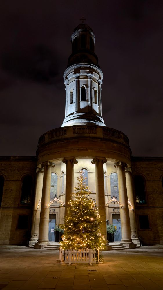 St. Mary’s Church in Marleybone, London. Picture taken at night, with the Christmas tree lit up in front.