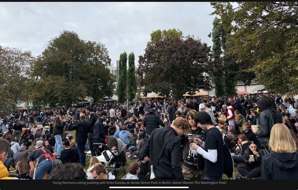 Young Germans eating pudding with forks Sunday at James Simon Park in Berlin. (Aaron Wiener/The Washington Post)
