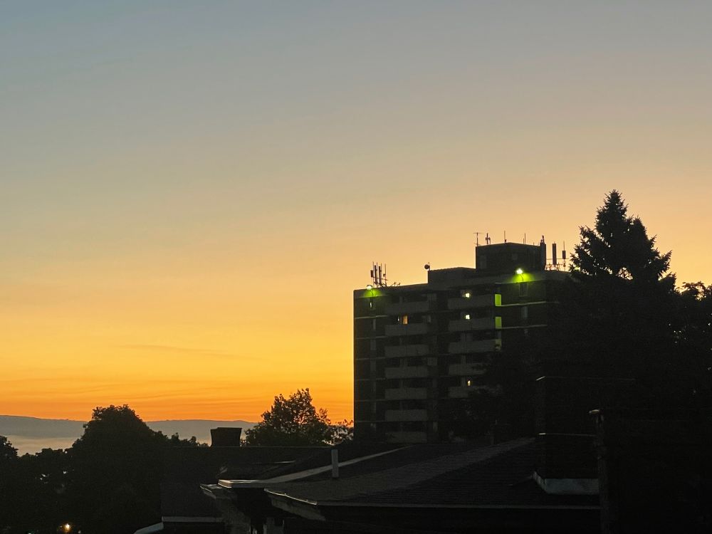 Sunrise behind an apartment building in Utica, NY