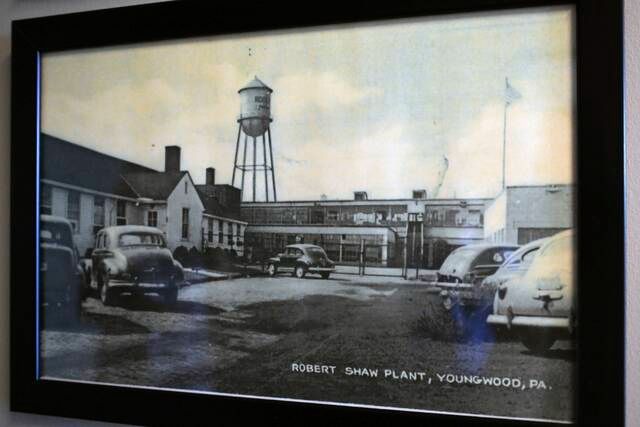 Photo of cars parked outside a factory, ca. 1940s