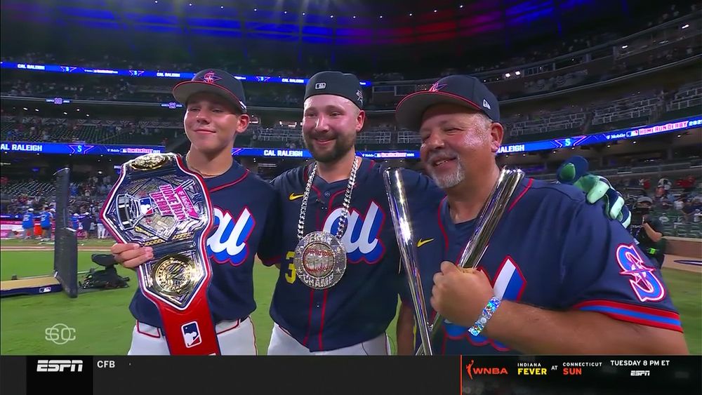 Todd Raleigh Jr holding a wrestling style title belt, Cal wearing the HR Derby chain, and Todd Raleigh Sr holding the HR Derby trophy