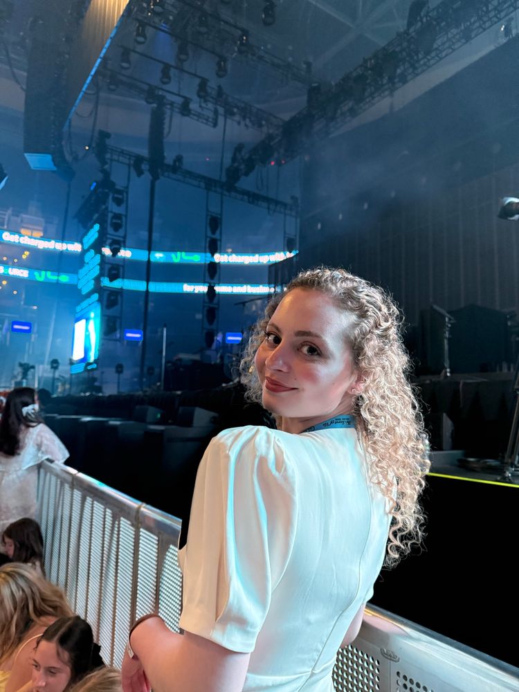 gracie abrams deluxe tour night 1 td garden boston. me in my dress. white with black bows. barricade over the shoulder smiling 
