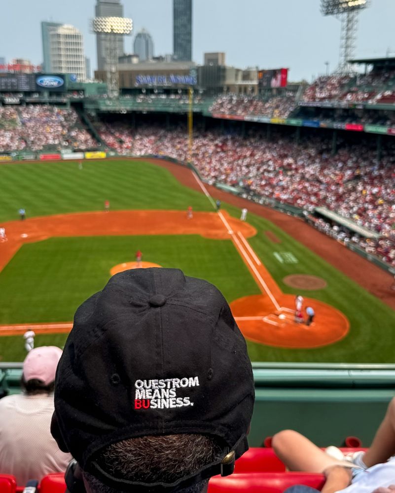 Questrom Means Business hat focused of someone at a Red Sox game in Fenway