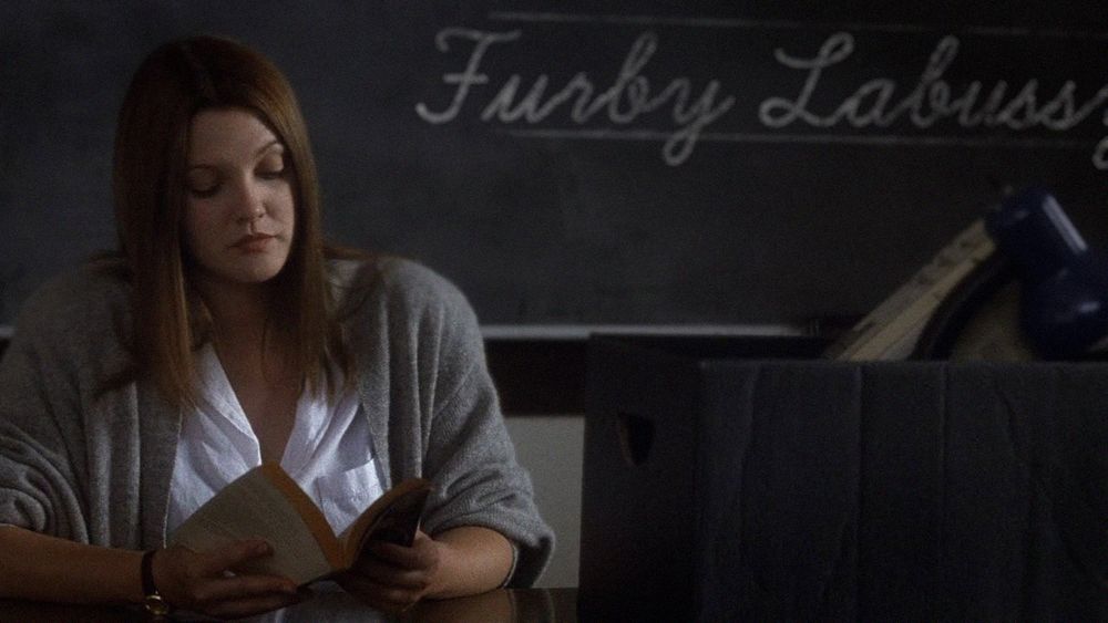 A real screengrab from the film, Donnie Darko. The words, "Furby Labussy" written on a blackboard behind Drew Barrymore.