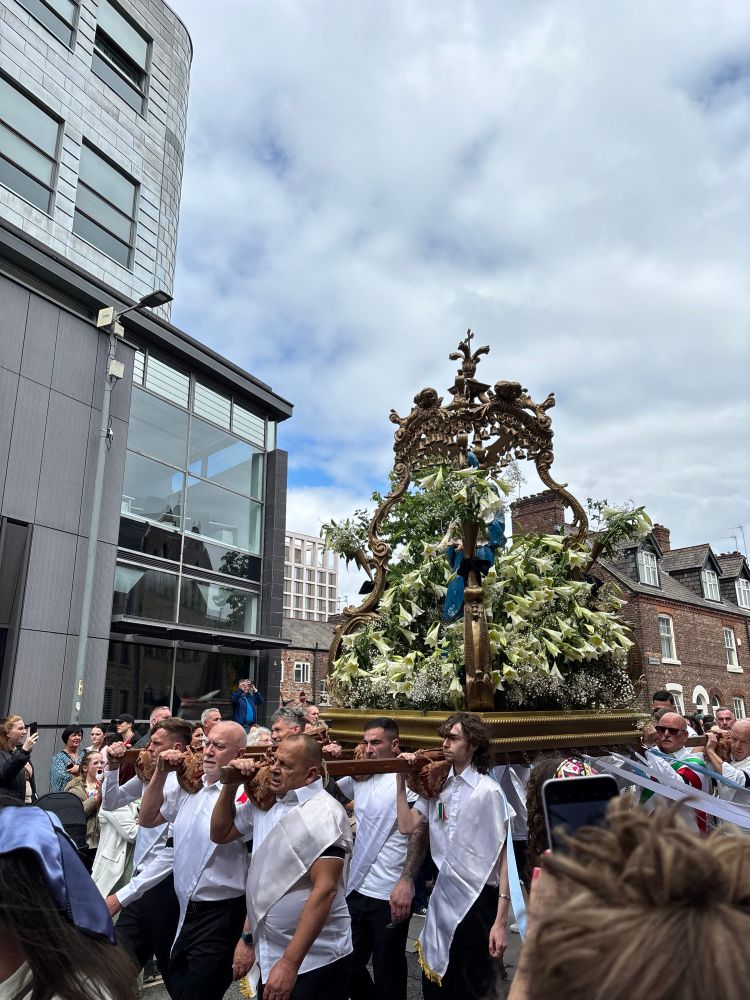 Crowds take part in the Madonna del Rosario procession in Ancoats.