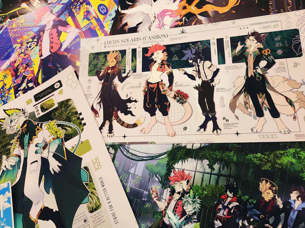 image is a photograph of a variety of art prints featuring the artist's anthropomorphic characters. #furryart #furry