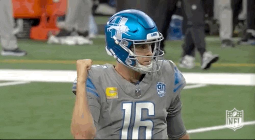 a football player wearing a helmet and a number 16 jersey is standing on a field .