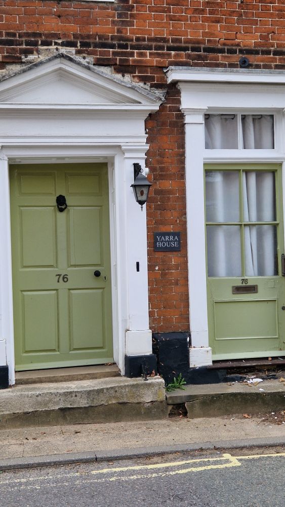 A photograph of a front door. A sign says 'Yarra House'