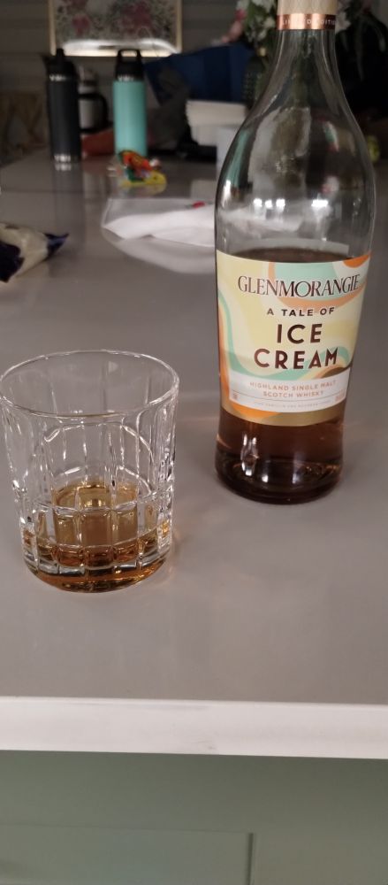 Glen Morangie "A Tale of Ice Cream" whisky bottle with a partially finished drink in a glass next to it. 