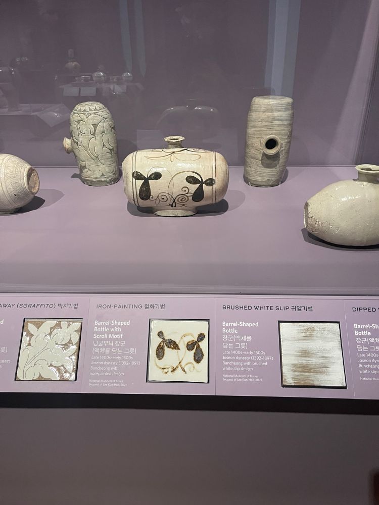 A photo of several Korean ceramic styles, with a focus on the barrel-shaped bottle with scroll motif as an example of an iron painting.