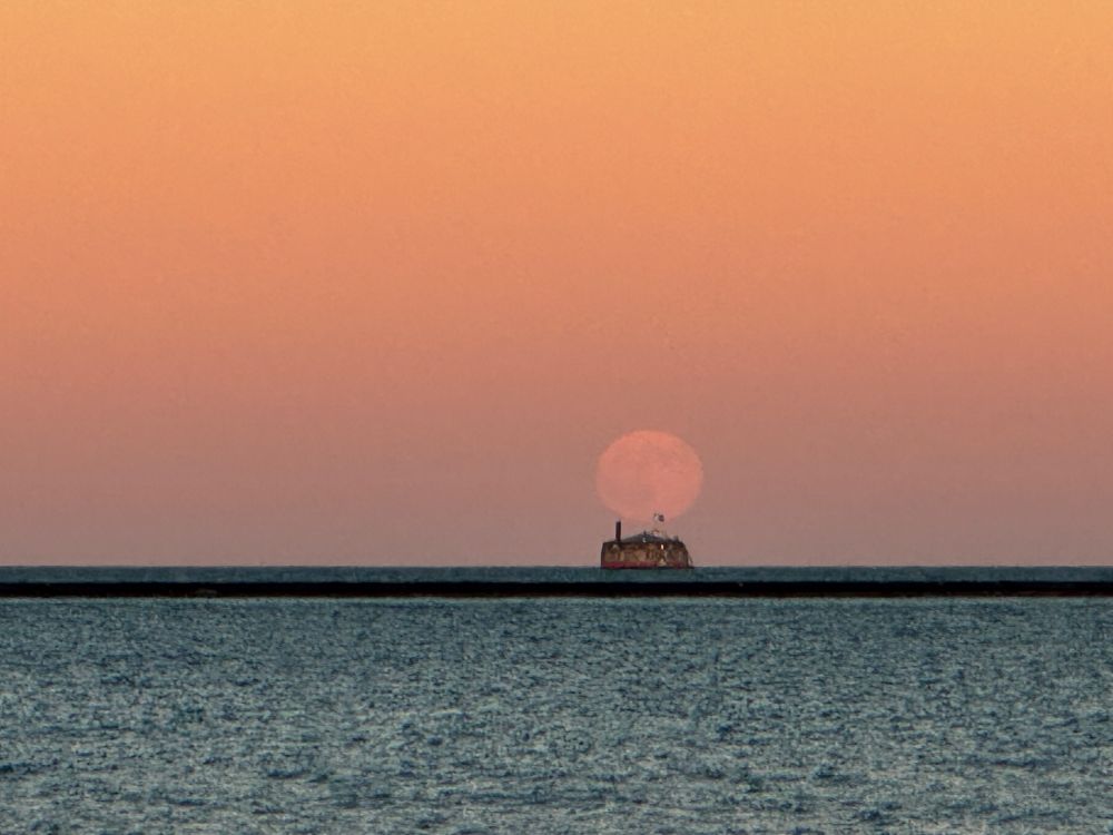 Moon rising over water intake crib in Lake Michigan 