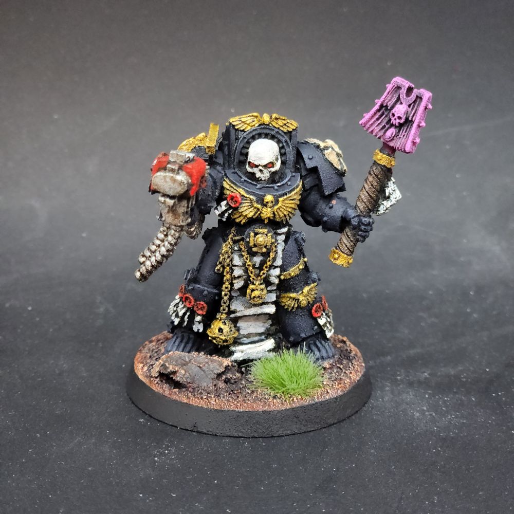 Chaplain in Terminator armour with a pink energy glowing crozius arcanum