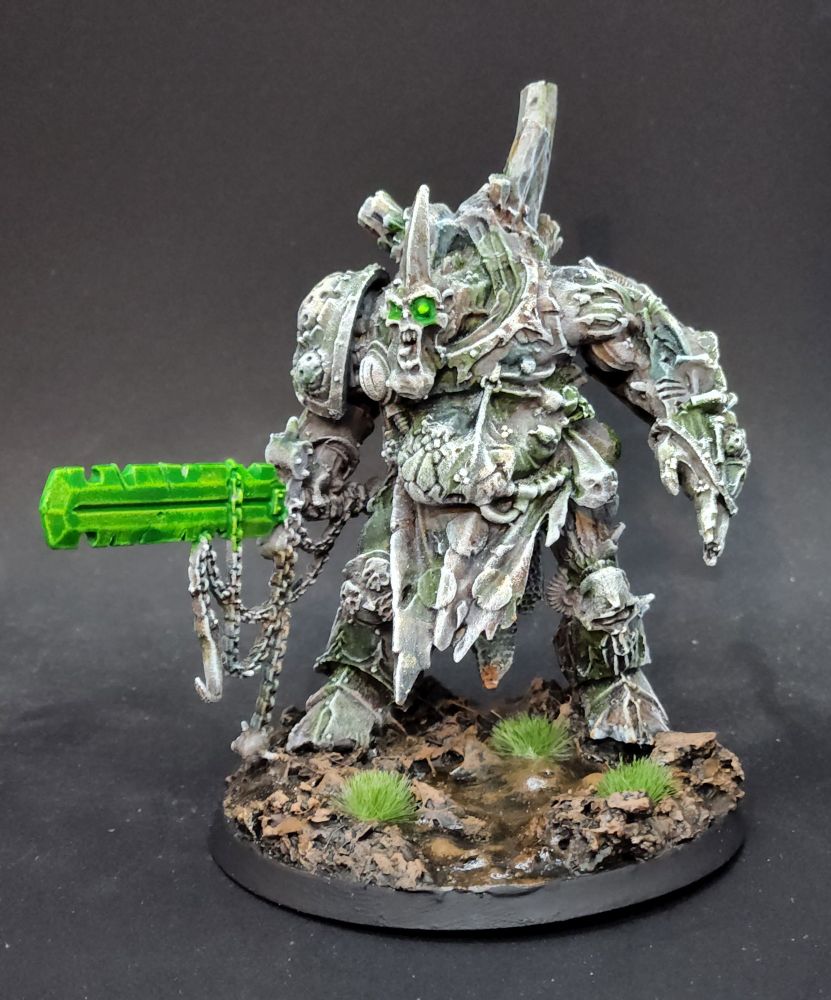 Nurgle Daemon Prince painted like a statue with glowing green weapons and eyes