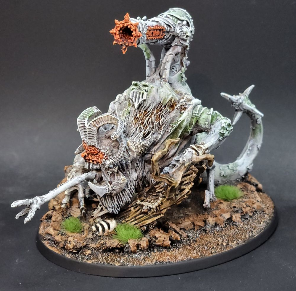 A Skull Cannon of Khorne converted from a finecast Jabberslythe model painted similar to a weathered stone statue with orange glowing energy effects 