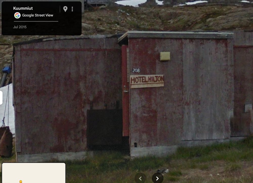 Tiny wooden shack with 'hotel hilton' written on it. 