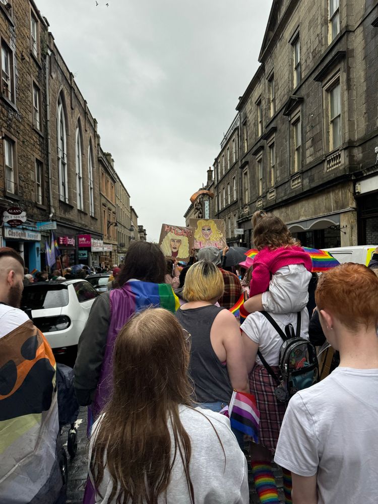 A photo of Dundee pride march walking down a street.
