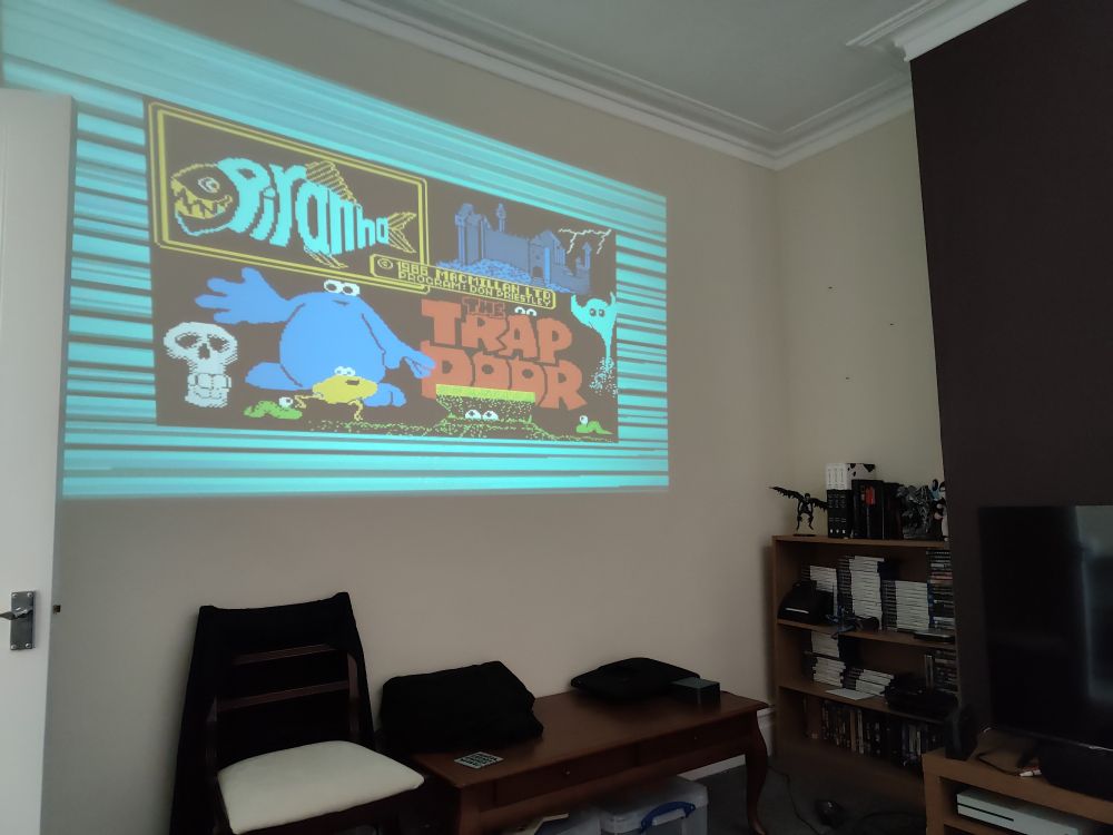 The ZX Spectrum game, Trap Door, loading on a miSTer via cassette and being displayed via a projector