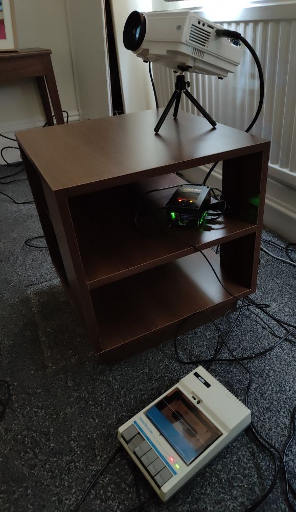 A photo of a miSTer connected to a cassette player and projector