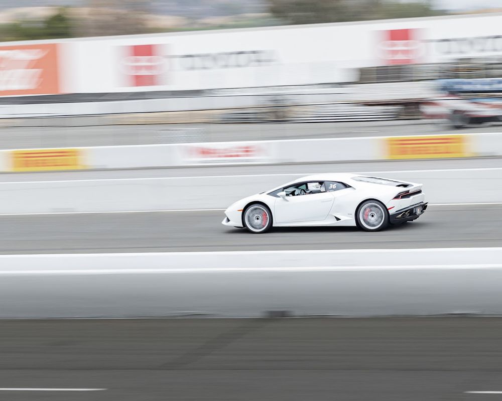 Picture of a Lamborghini Huracan racing at Infineon Raceway in Sonoma, California. This event was a track day event where you paid to be able to race in differing Super Cars