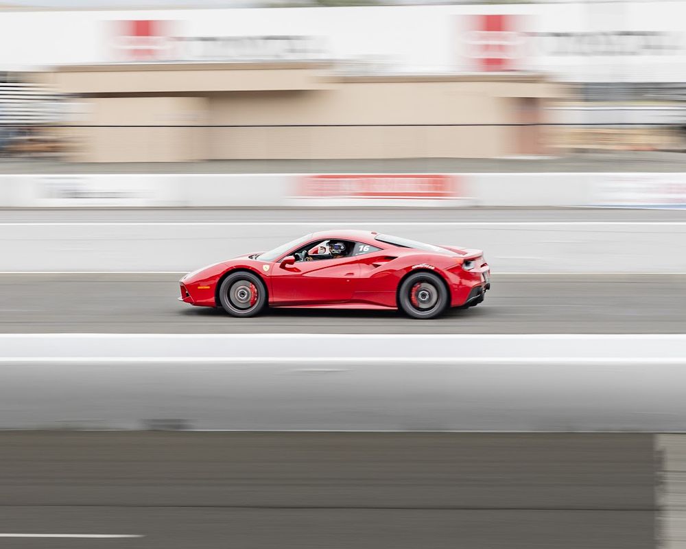 Picture of a Ferrari 458 racing at Infineon Raceway in Sonoma, California. This event was a track day event where you paid to be able to race in differing Super Cars
