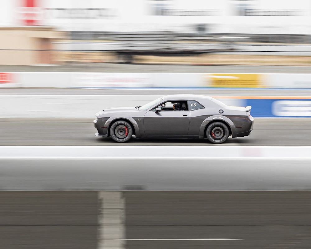 Picture of a Dodge Hellcat racing at Infineon Raceway in Sonoma, California. This event was a track day event where you paid to be able to race in differing Super Cars