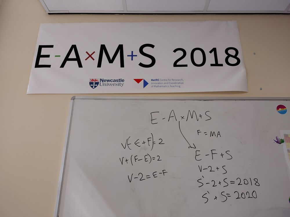 A conference banner with a logo that looks like the equation "E - A×M + S = 2018", above a whiteboard with some maths which is in the text of the post. 