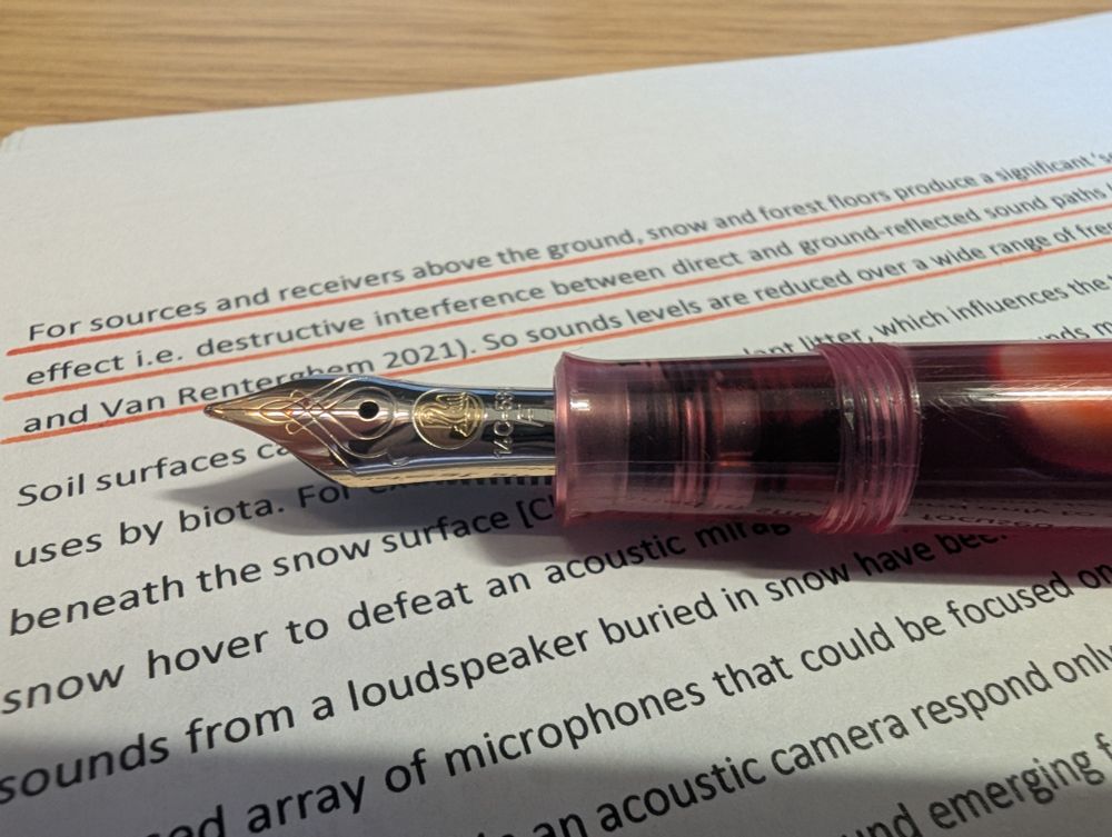 Pelikan M400 gold nib in pink M205 Pelikan fountain pen. Resting on a work in progress paper with orange (Yu Yake ink!) edits. 