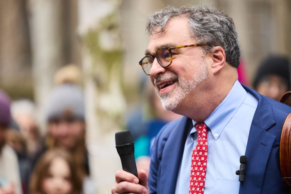 A photo of HIAS President, Mark Hetfield, speaking at a rally in support of welcoming refugees.