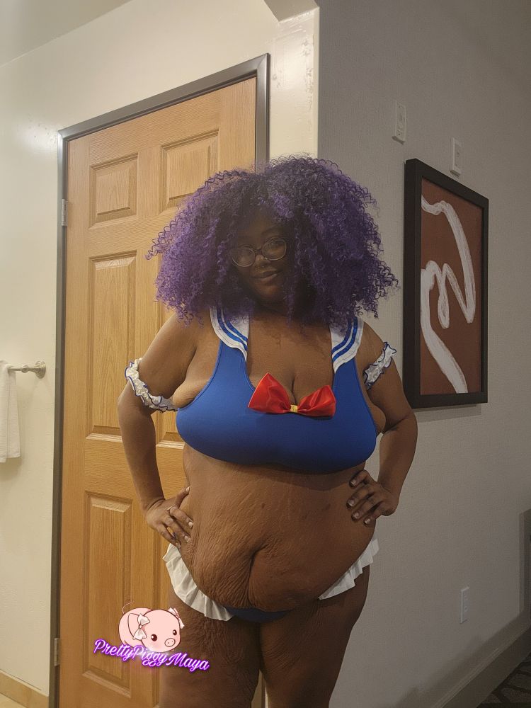 Maya is in a two piece bathing suit

The top looks like it was made to look like the outfit Sailor Moon wears, with its blues, whites, and red. The bottoms are rimmed with frills and the rest is blue