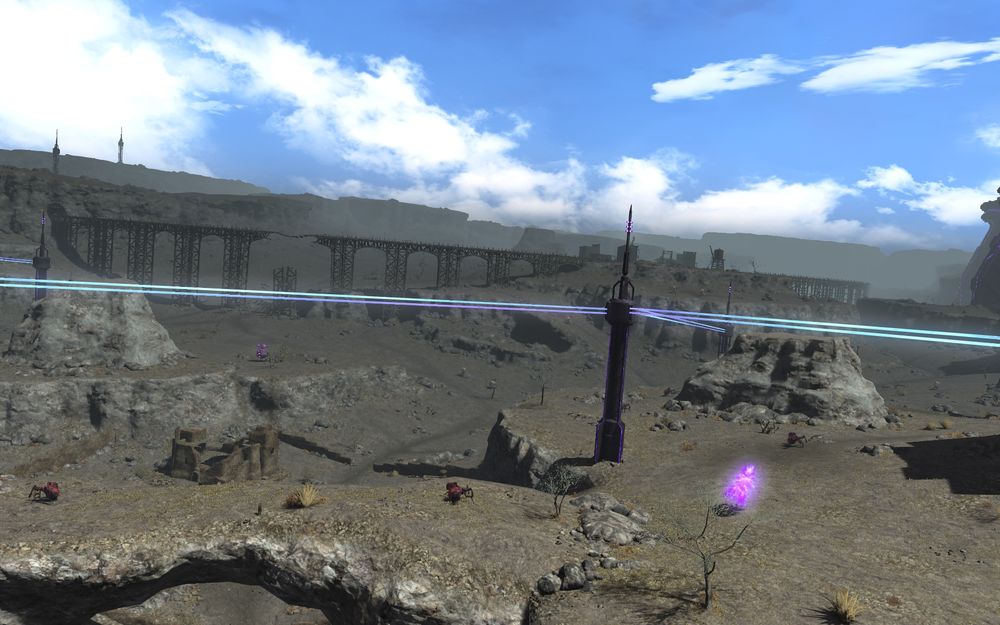 A rocky terrain with blue skies featuring some fantasy monsters and science fiction electrical power lines.