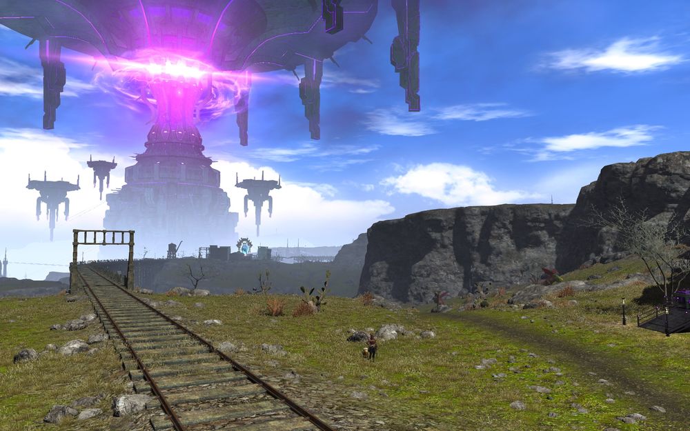 Train tracks on a grassy terrain with a big menacing sci fi style tower in the distance.