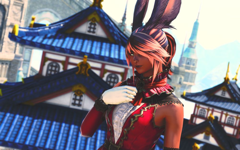 A Viera character in Final Fantasy XIV, wearing a rolanberry red coloured dress standing against a slightly out of focus background featuring Eastern Asian inspired buildings.