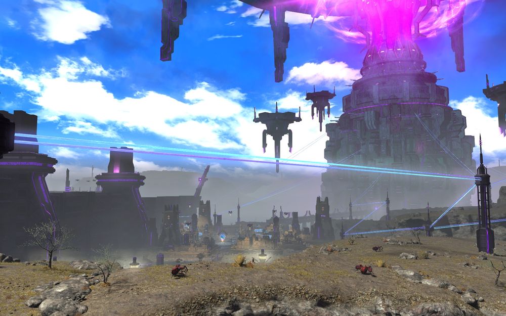 Screenshot of a fictional town with a looming big sci-fi tower looming behind it. Foreground has rocky dirt terrain with some fantasy monsters roaming.
