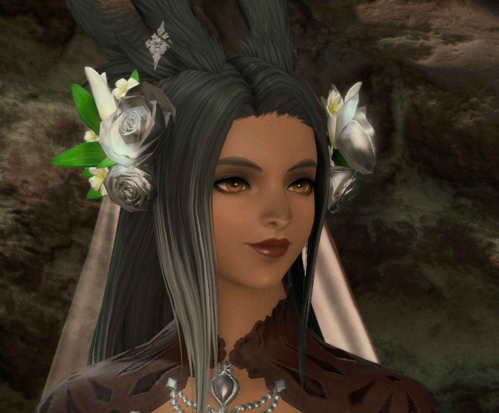 final fantasy 14 screenshot showing a with viera / bunny woman with medium beige skin, in dark make-up with black and grey hair, she is wearing a dark red dress with silver jewelry and a veil with silver roses and white lilies. she is looking off-screen and is smiling