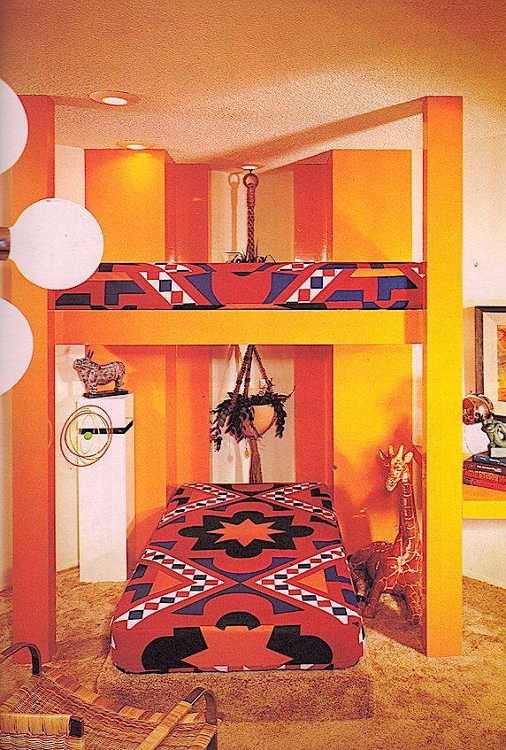 The home of designee Bruce Stodolla (1976) Saffron yellow bunkbeds covered with the Bedouin style mandala fabric in red, blue orange, black and white geometric designs and chevrons.