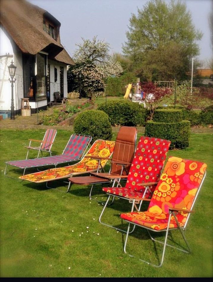 An assortment of 1970s aluminum-framed lawn chairs with colorful, woven polypropylene seats, a design that emerged post-World War II when manufacturers repurposed surplus aircraft aluminum for lightweight, foldable outdoor furniture.