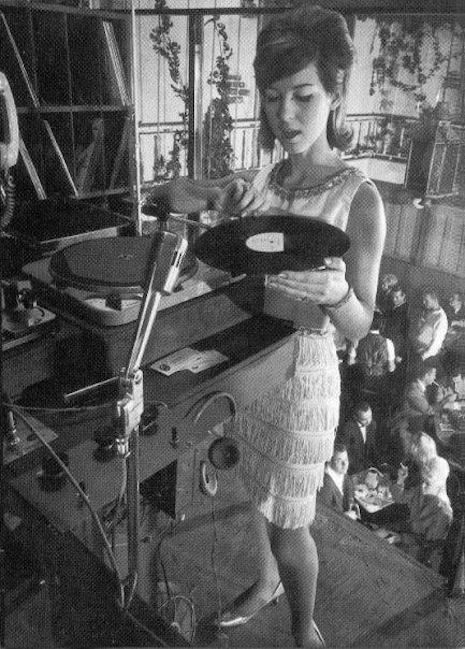 DJ Joanie Labine in her suspended DJ booth above the crowd in 1964 