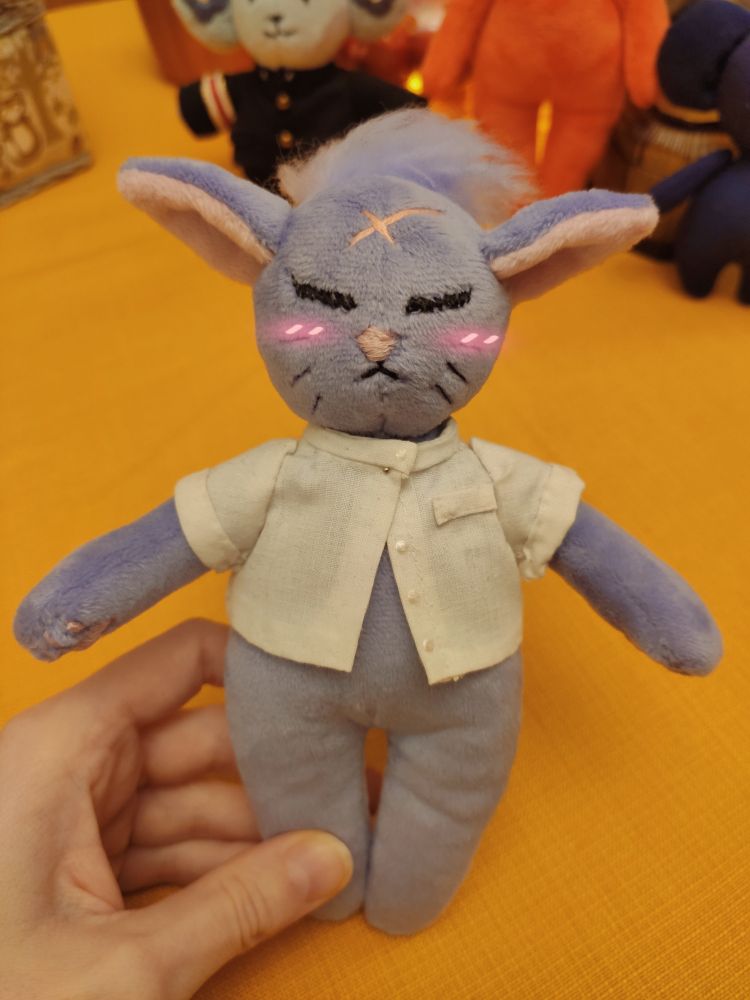 My Nyan Zieks handmade plush wearing a tiny white shirt a bit too small for him. A little blush on his cheeks. 